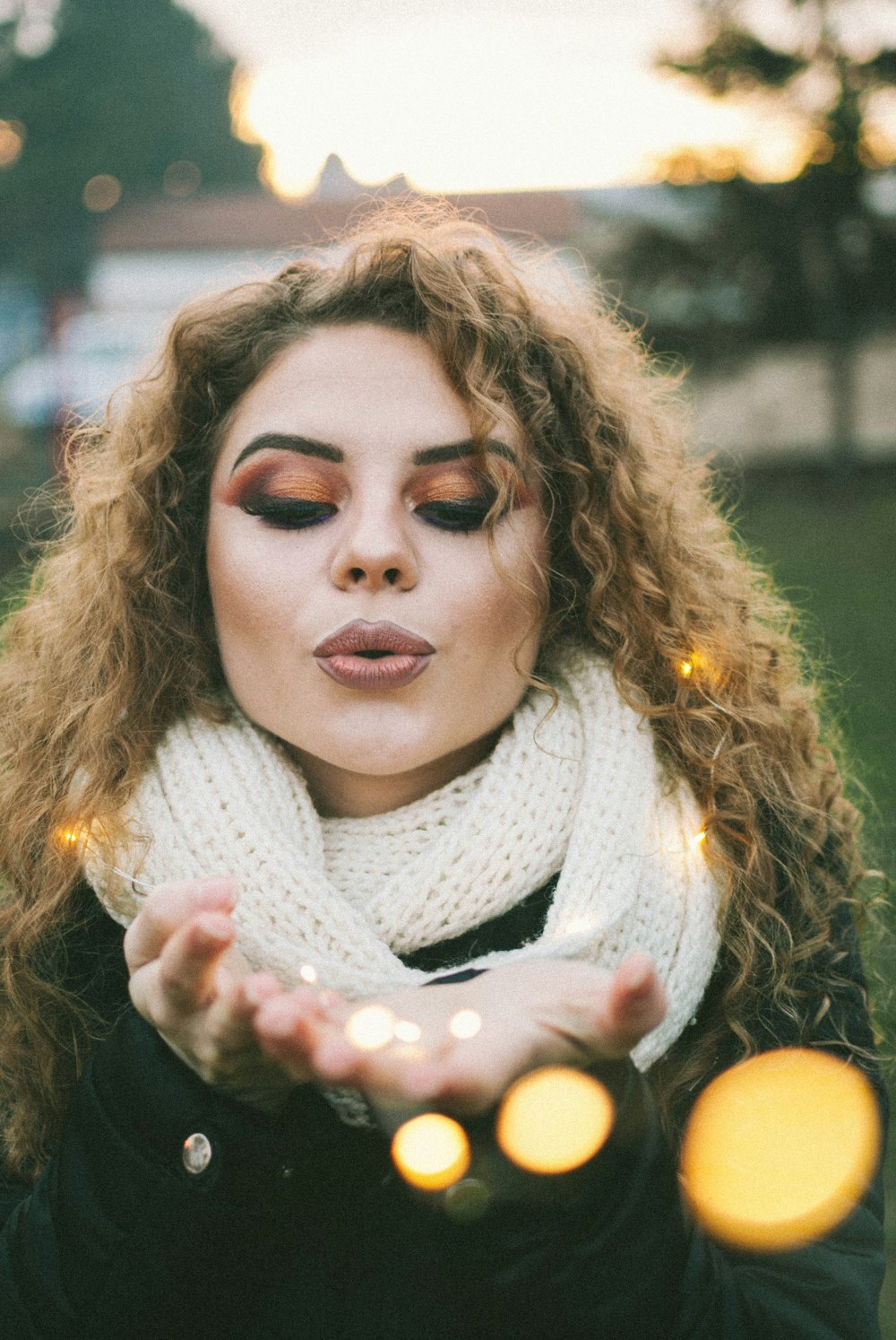 girl in white scarf holding yellow fruit