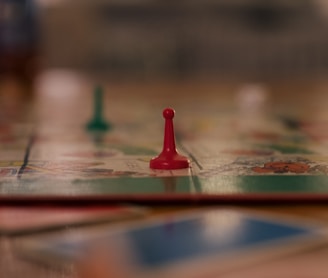 red and green chess piece on brown wooden table