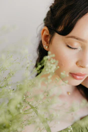 A serene woman with radiant skin surrounded by natural herbs and subtle digital elements symbolizing the fusion of Ayurveda and AI.