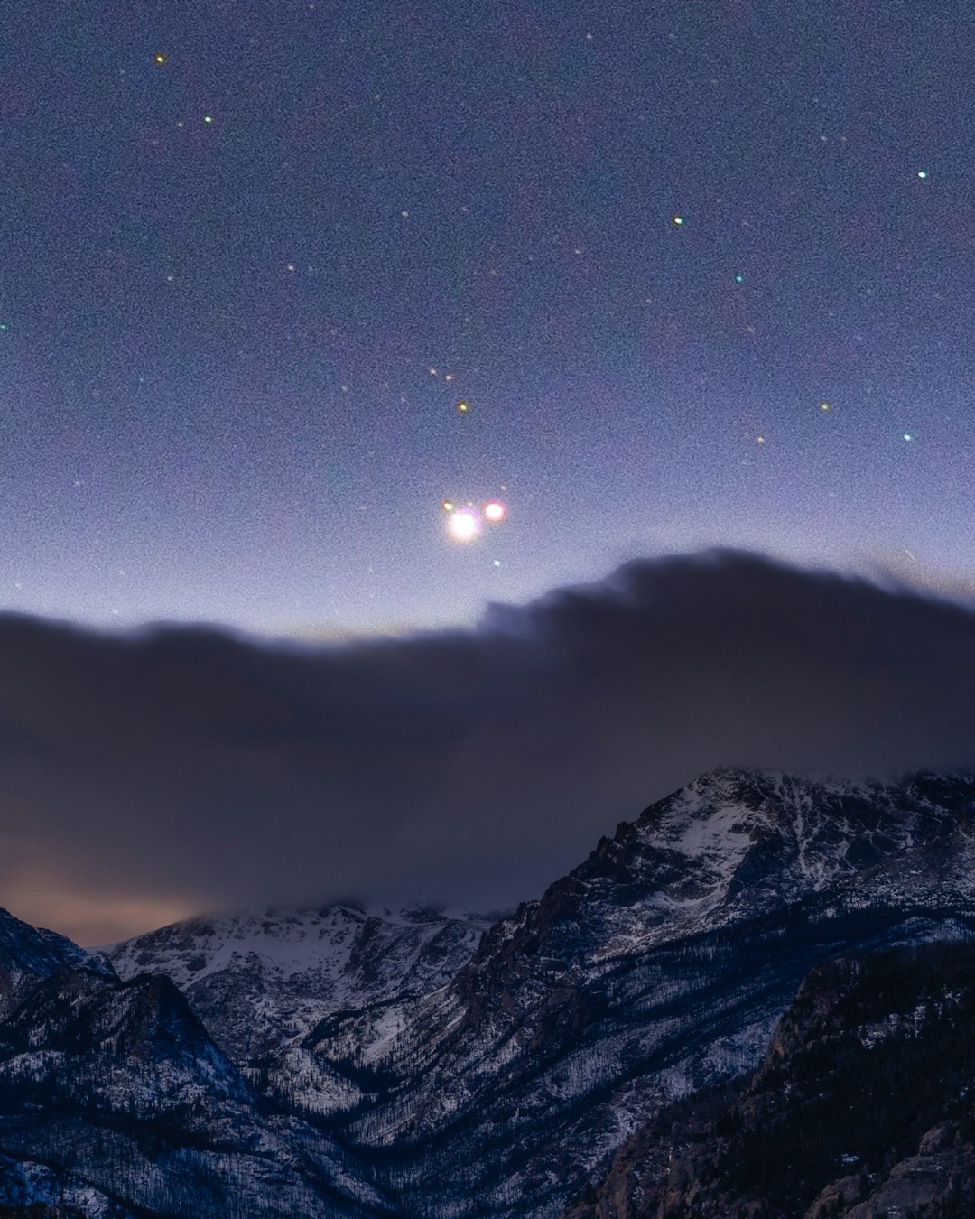 snow covered mountain under white clouds during daytime