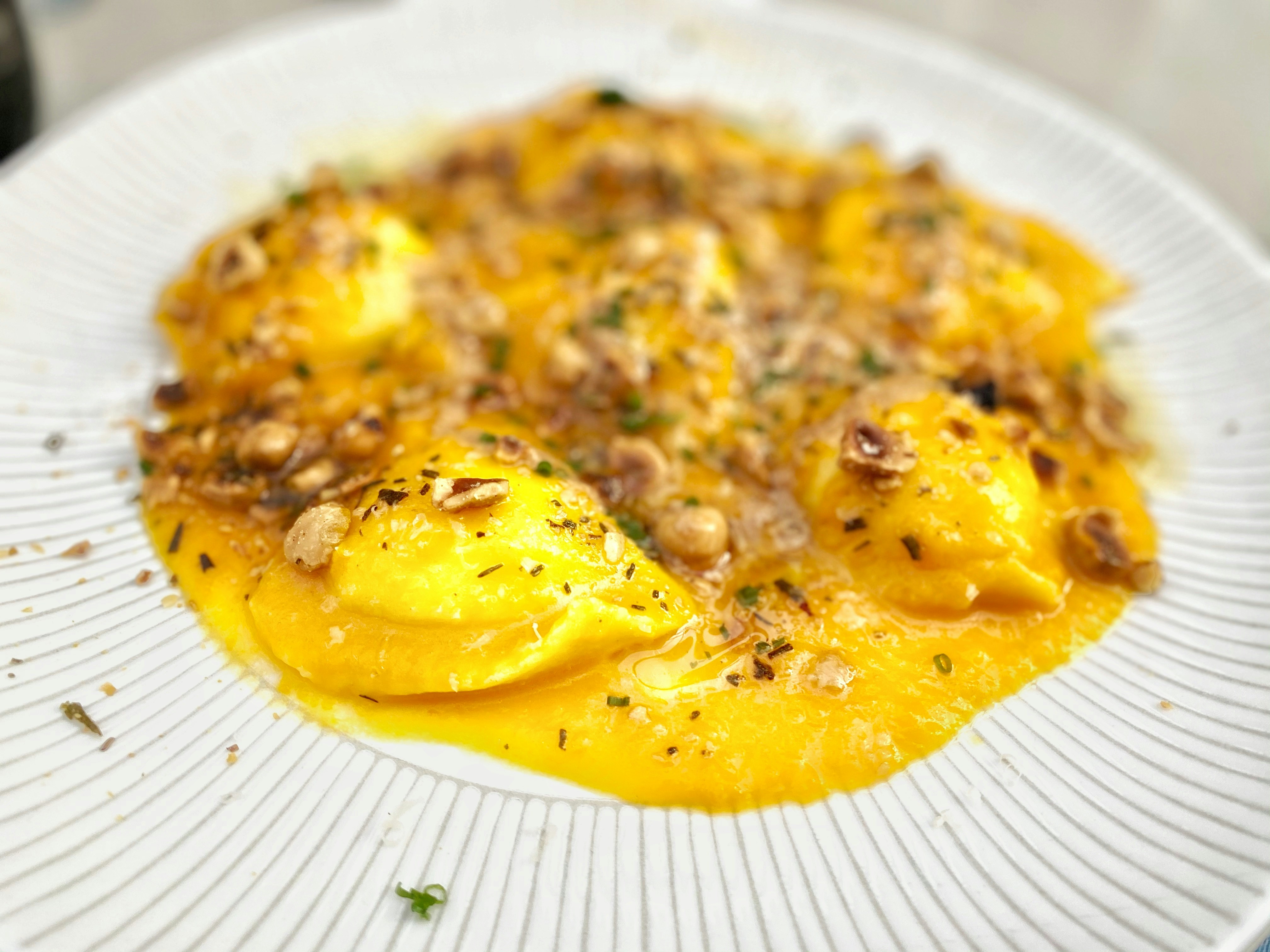 yellow food on white ceramic plate, Ricotta Ravioli.
