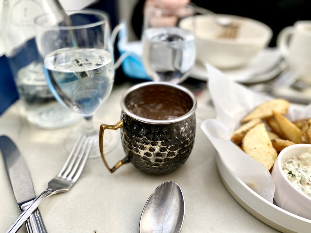 brown ceramic cup on white table