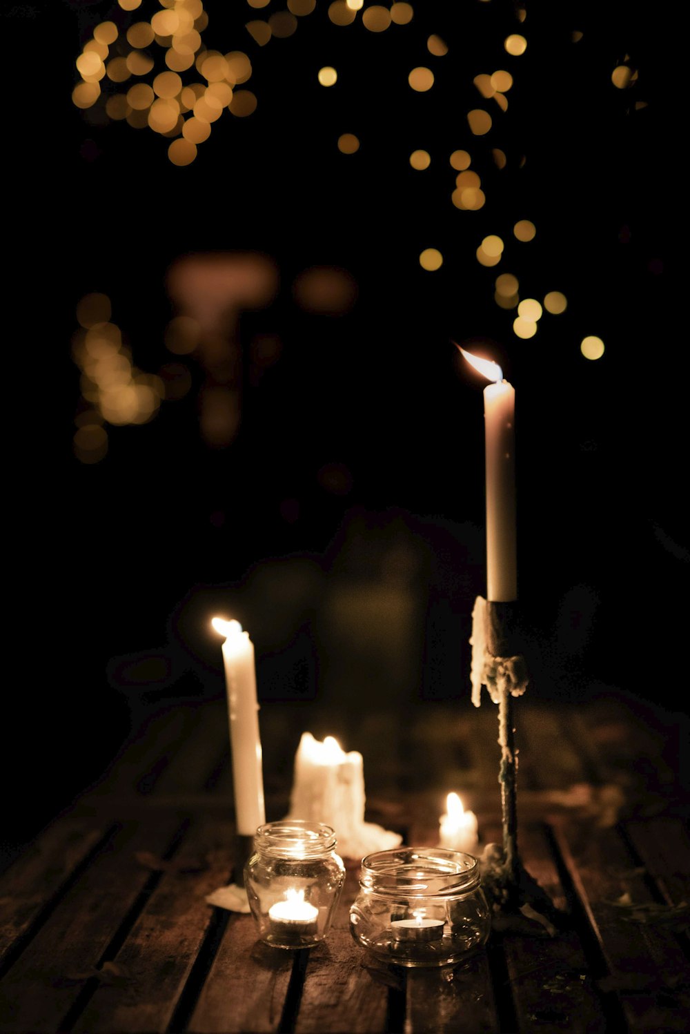 white candles on silver candle holder