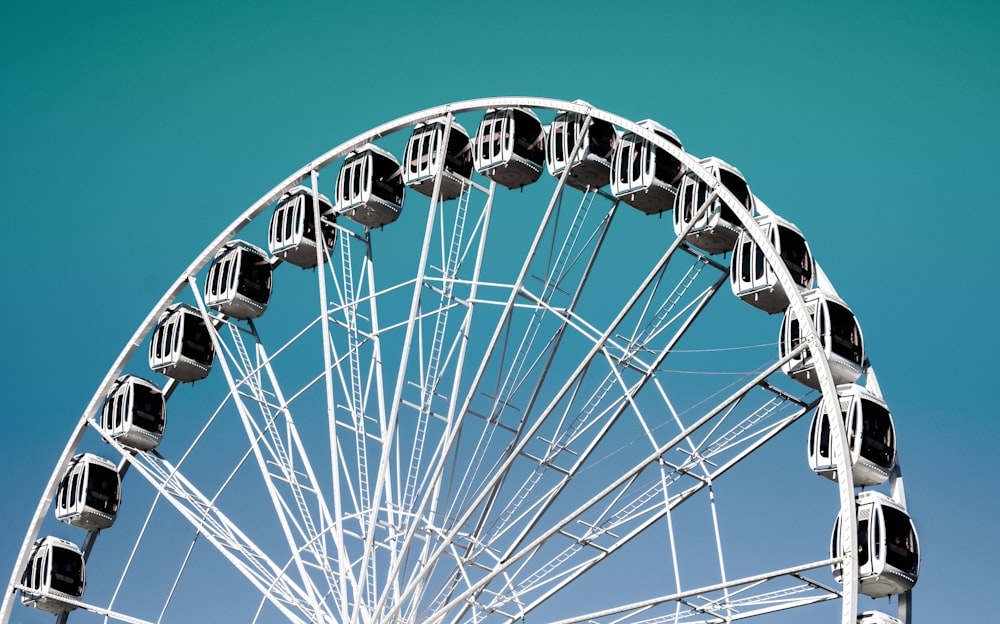 white and blue ferris wheel under blue sky during daytime