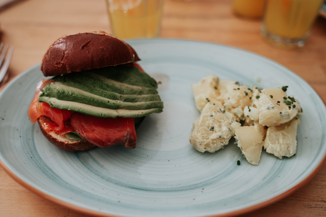 sliced meat with green vegetable on white ceramic plate