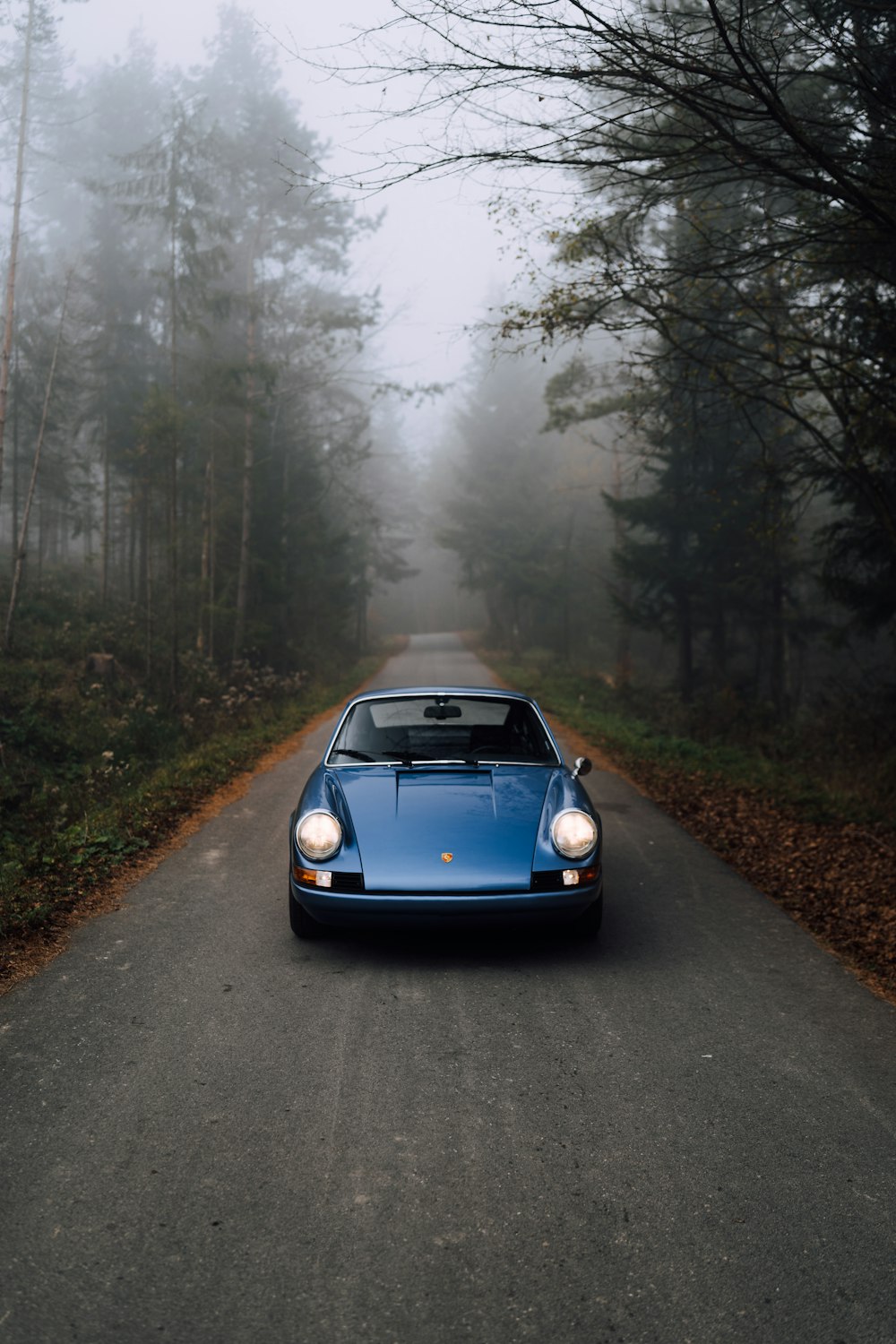 blue porsche 911 on road