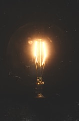 A glowing lightbulb emerging from a complex web of data streams, symbolizing moments of clarity.