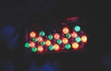 A dark background highlights a cluster of brightly colored LED lights. The lights are predominantly green and red, arranged in a rectangular pattern. They emit a soft, glowing effect against the darkness.