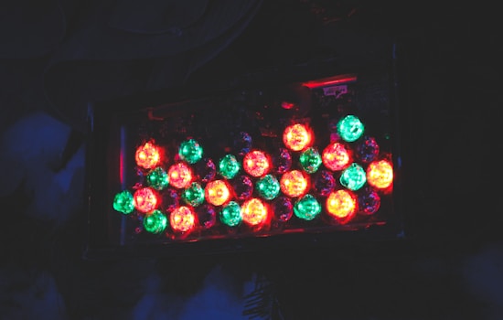A dark background highlights a cluster of brightly colored LED lights. The lights are predominantly green and red, arranged in a rectangular pattern. They emit a soft, glowing effect against the darkness.