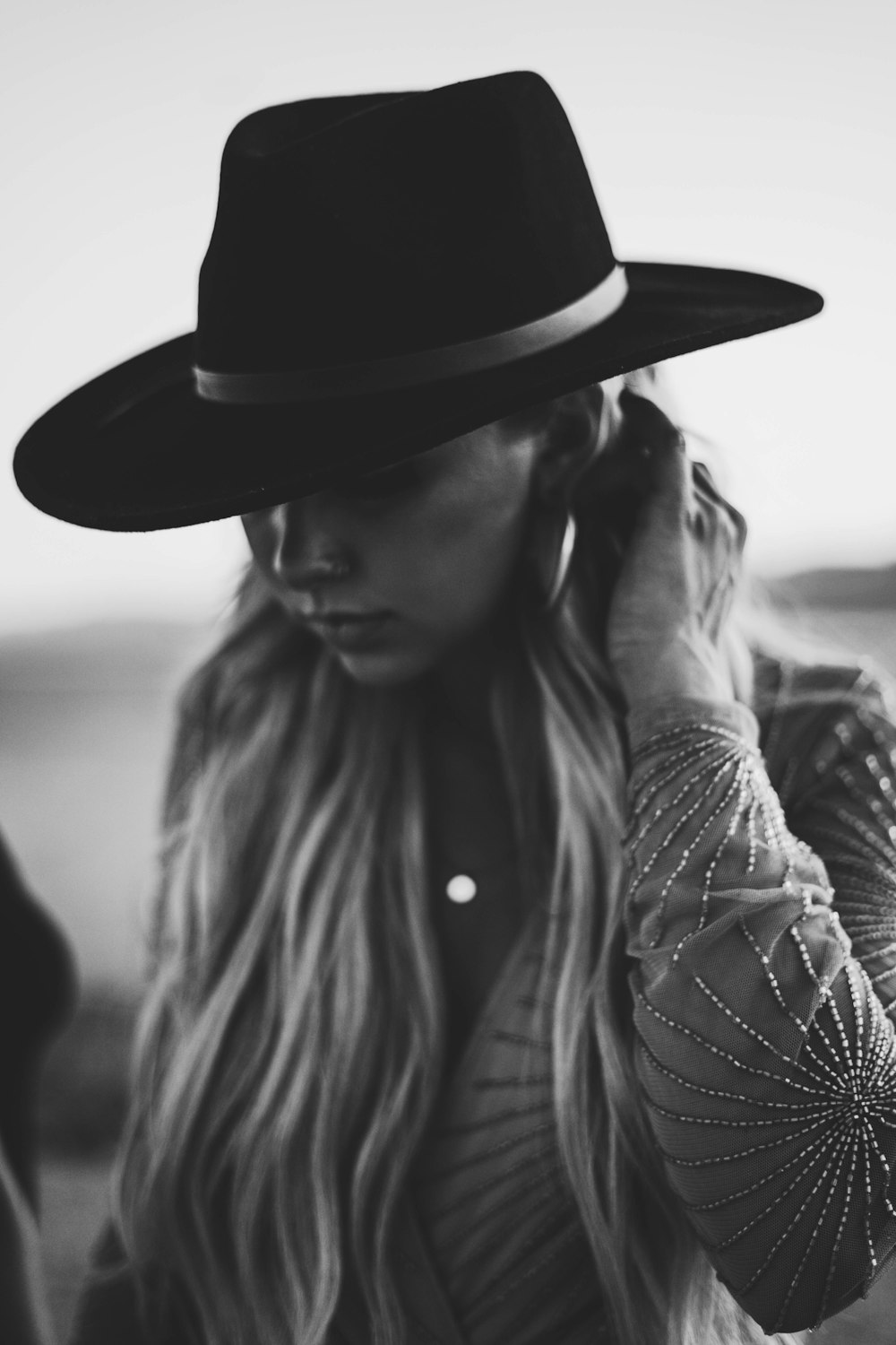 woman in black and white stripe long sleeve shirt wearing black hat