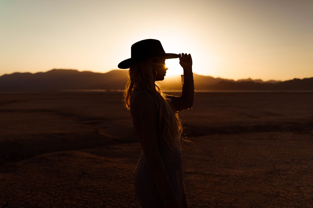 woman in white dress wearing black fedora hat