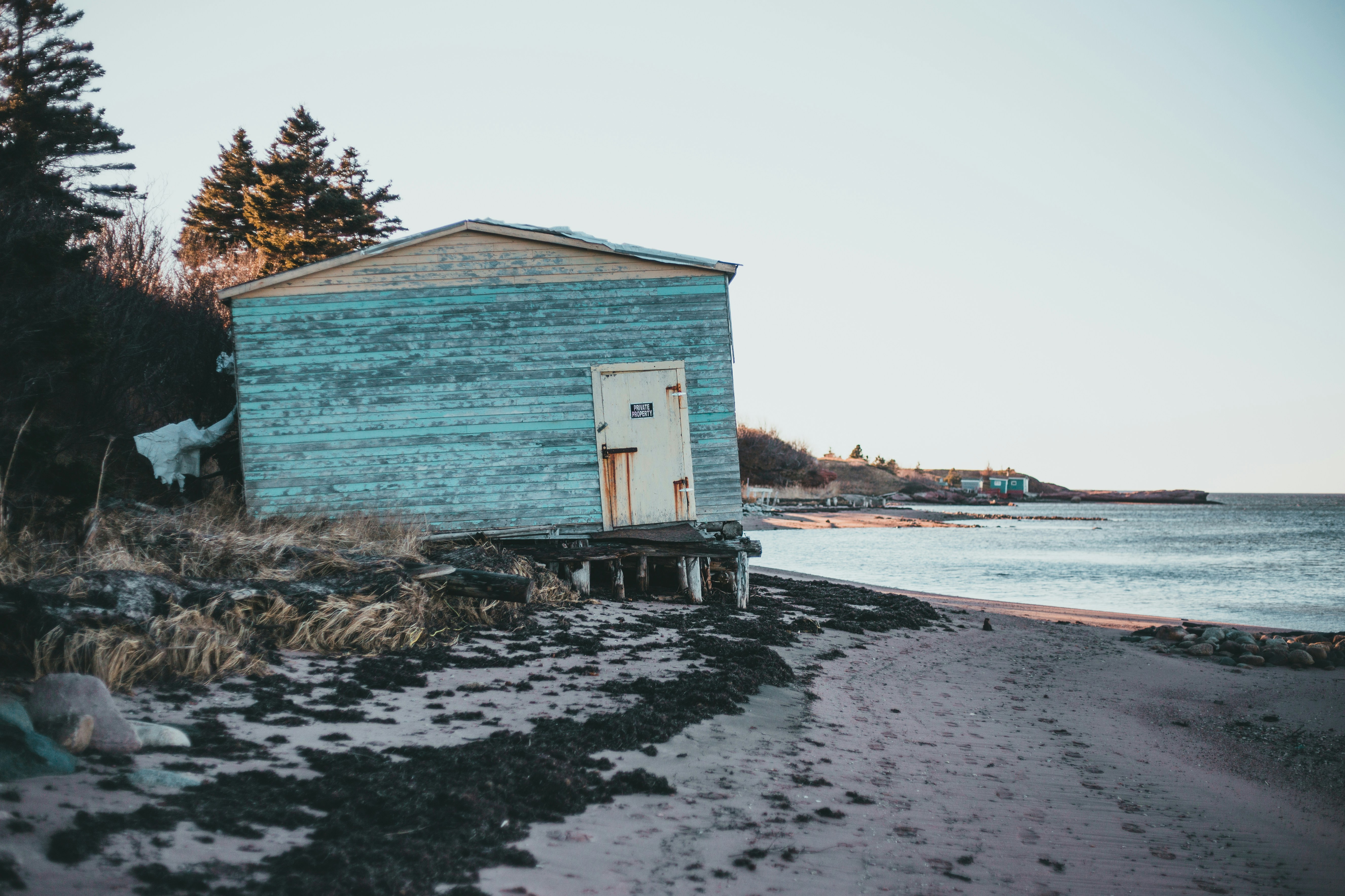 white wooden house near body of water during daytime