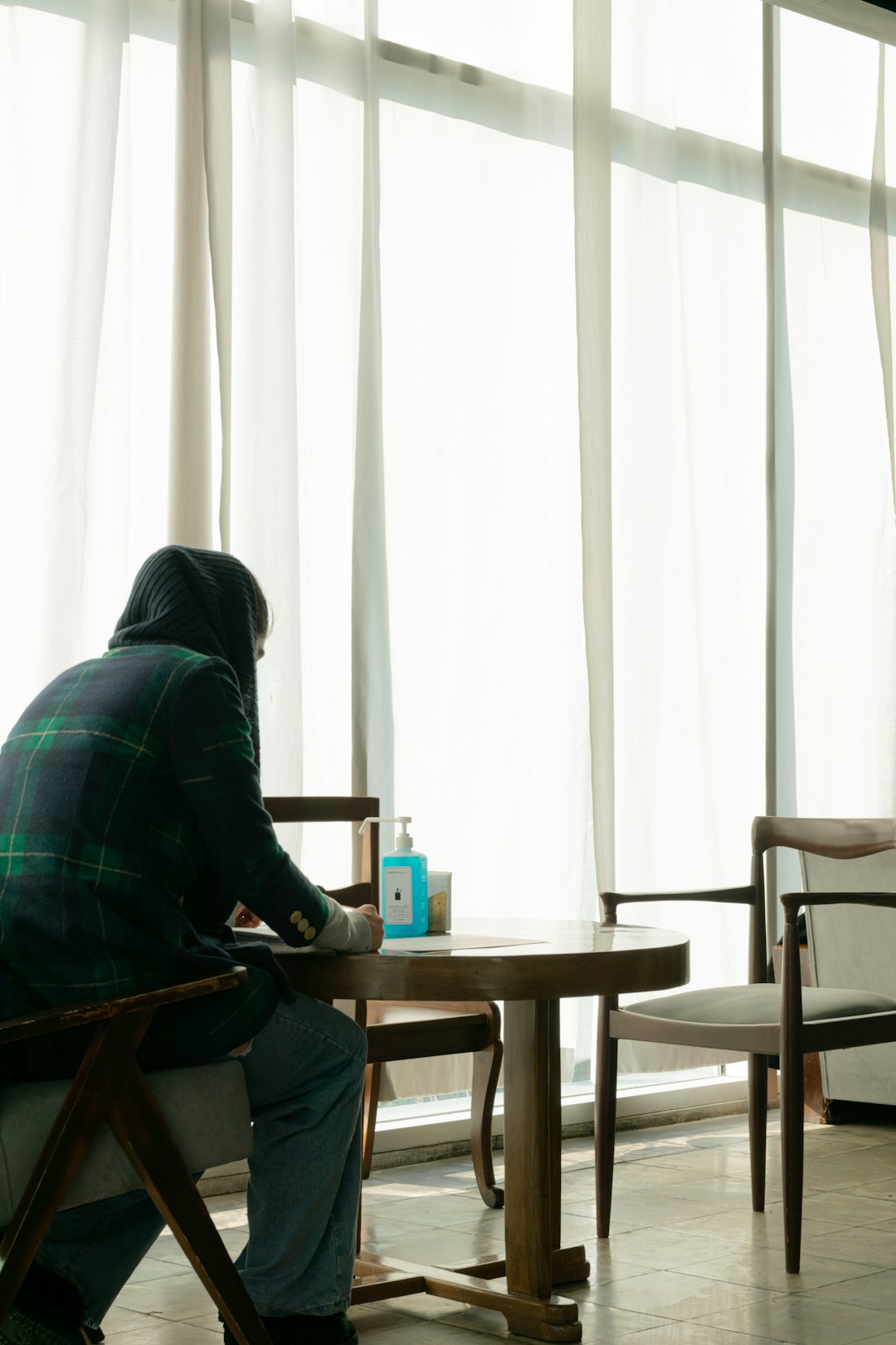 man in black jacket sitting on chair