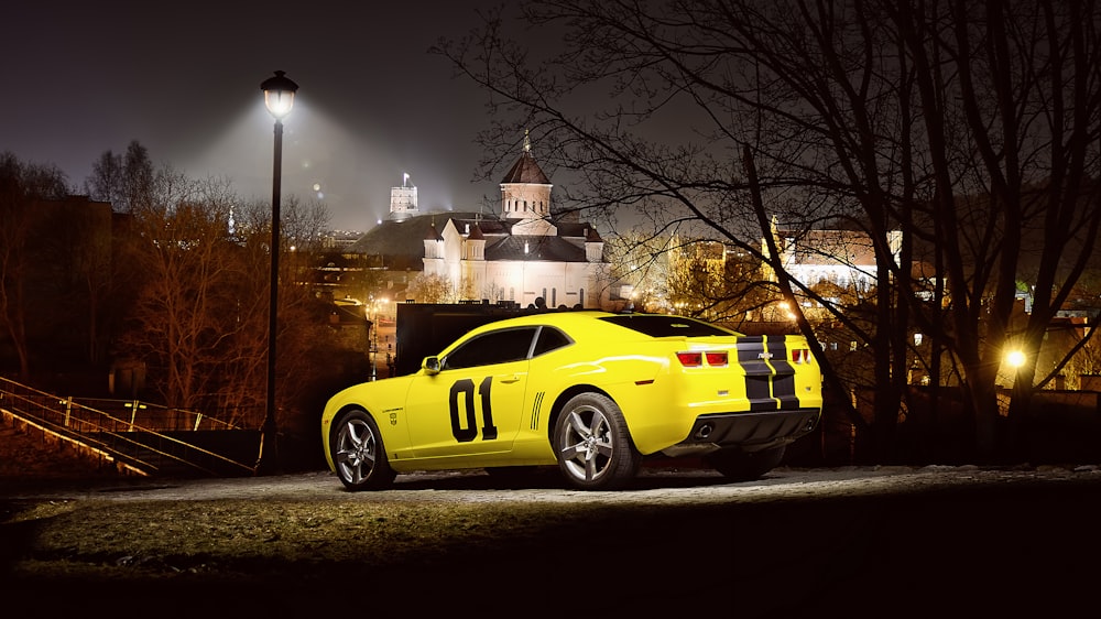 yellow and black coupe on road during night time