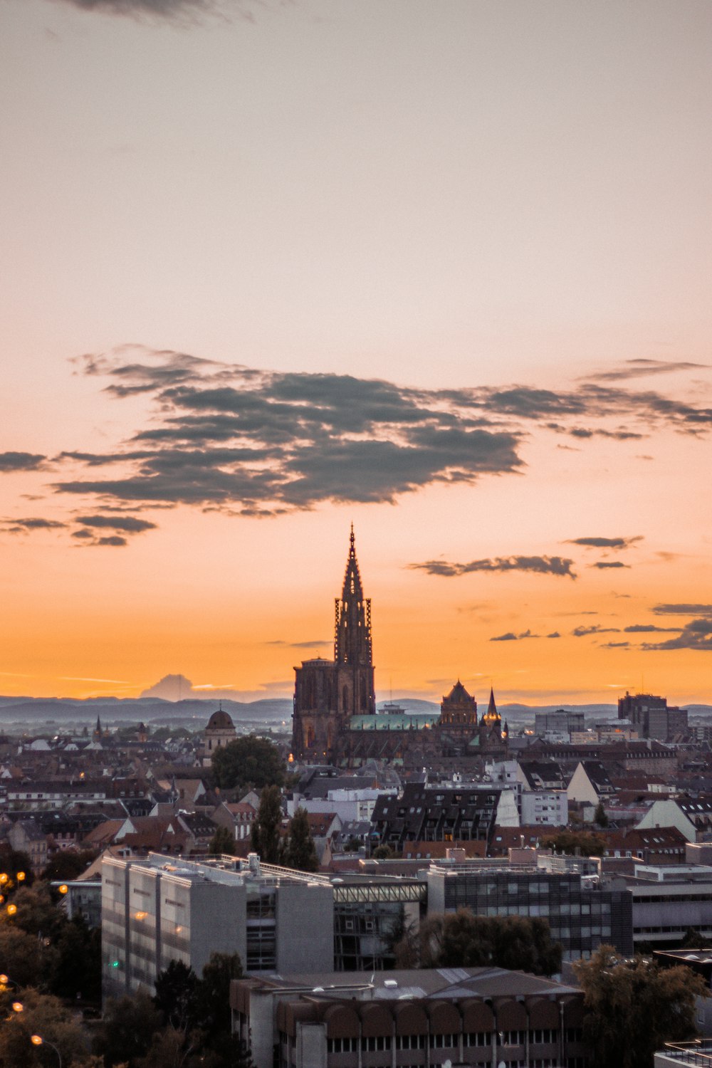 city buildings under cloudy sky during sunset