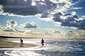 Cyclists riding along the rugged coastline of Côte Bleue with the sparkling Mediterranean Sea in the background