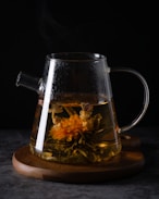 clear glass pitcher with brown liquid inside