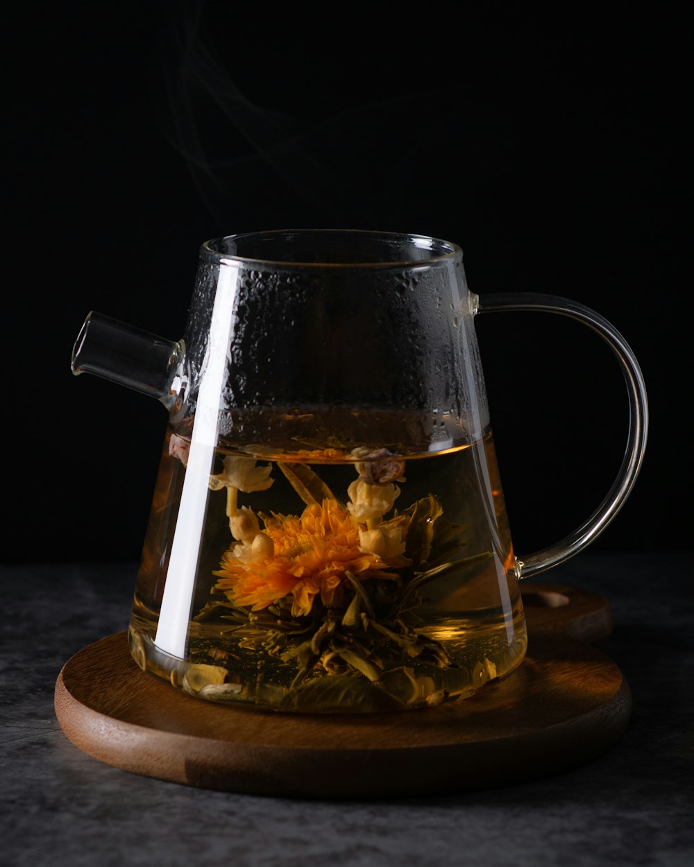 clear glass pitcher with brown liquid inside