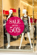 woman in black and white dress holding happy birthday signage