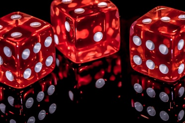 three red dice with white dots