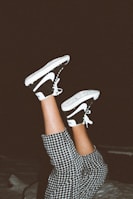 person wearing black and white nike sneakers