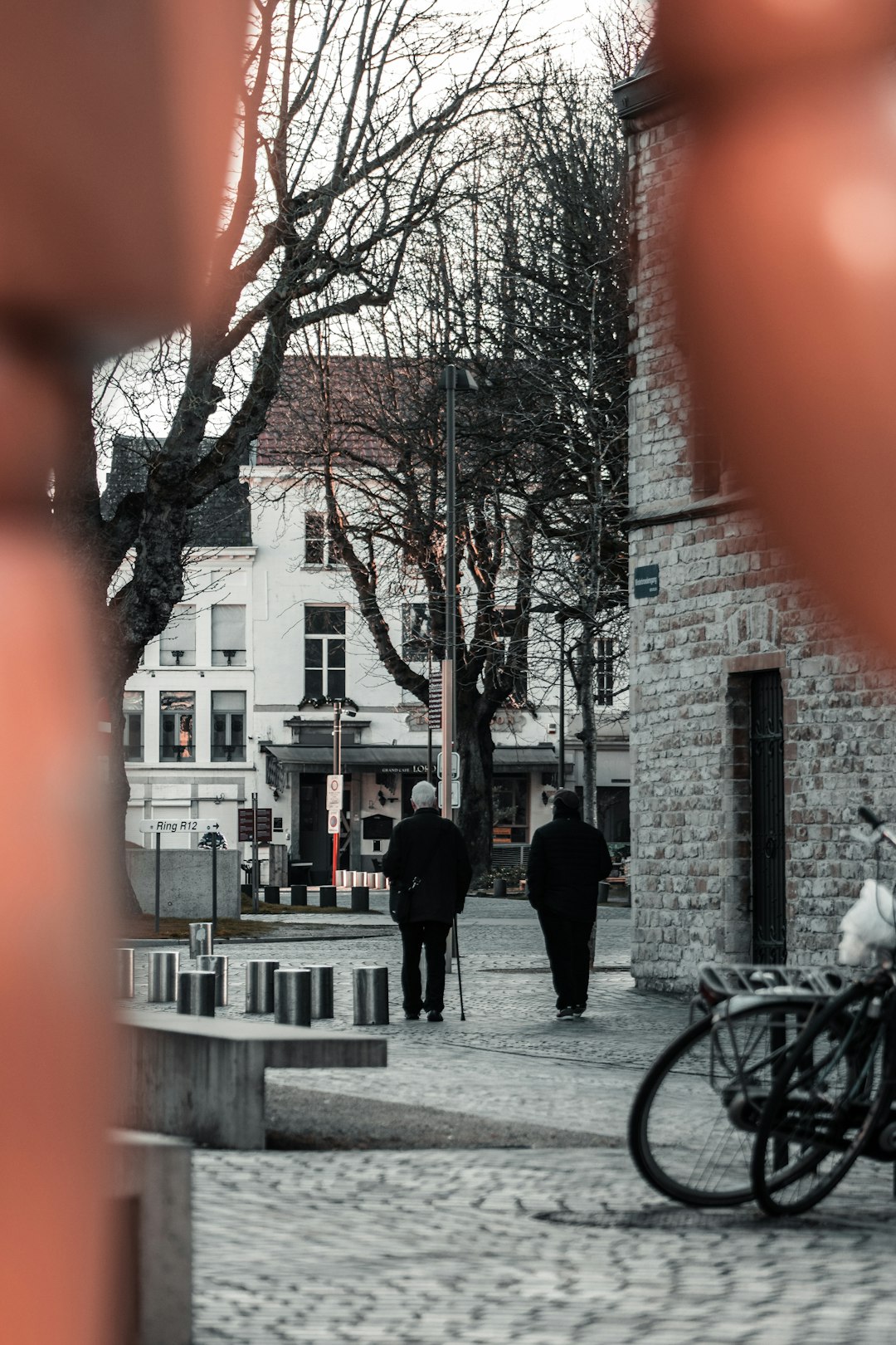 black bicycle parked beside black metal fence during daytime