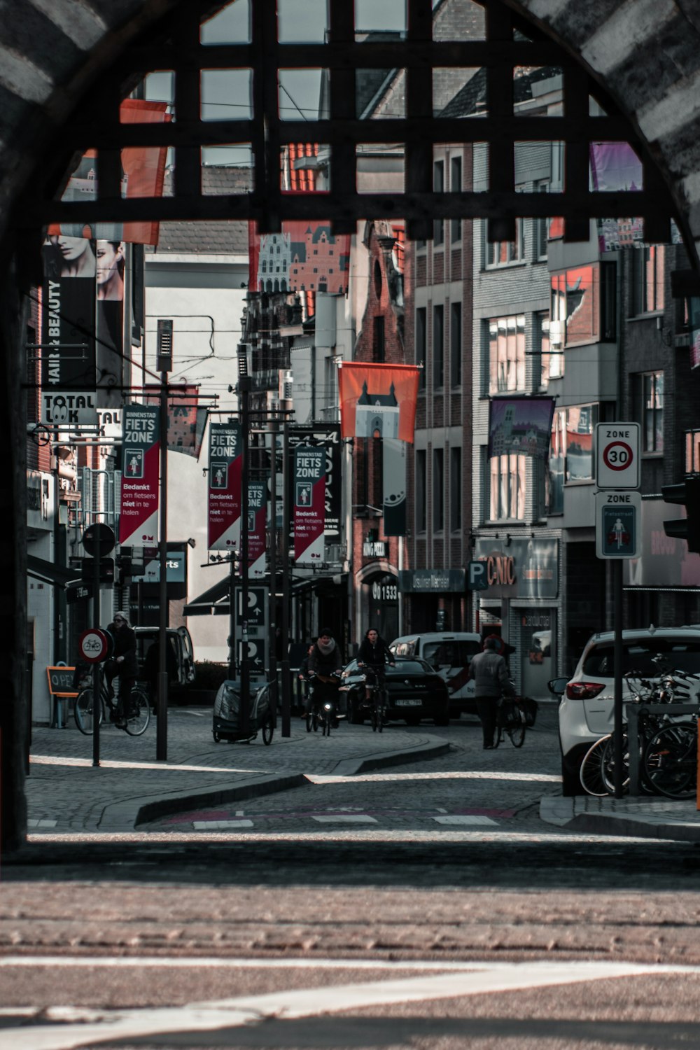 cars parked on sidewalk near buildings during daytime