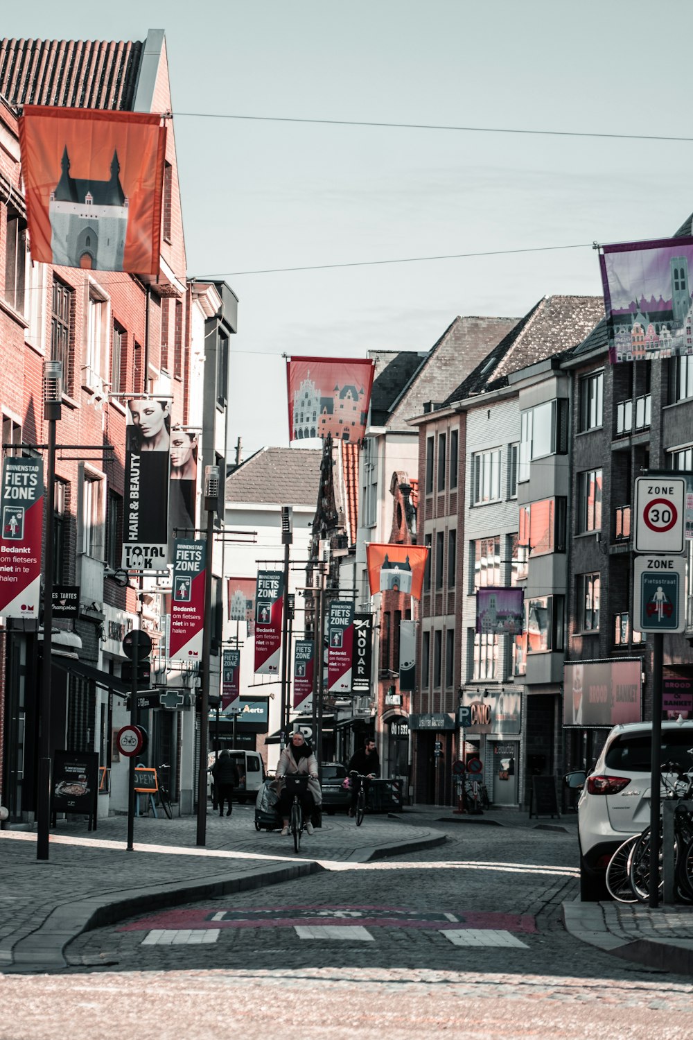 people walking on sidewalk near buildings during daytime