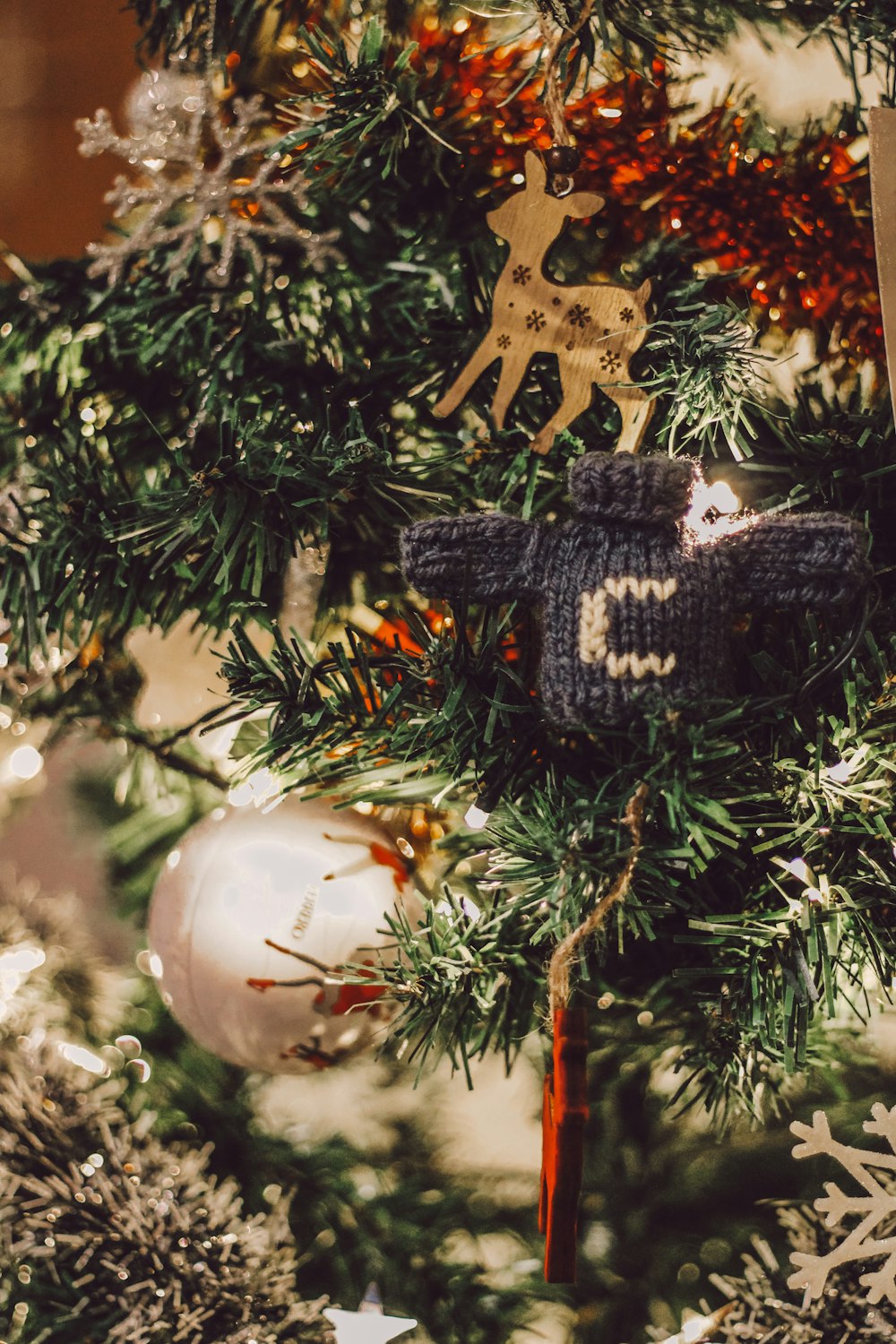 white and brown deer ornament on green christmas tree