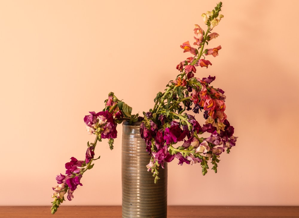 purple flowers in clear glass vase