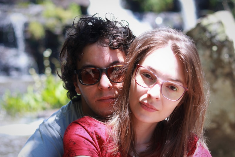 woman in red leather jacket beside woman in blue shirt