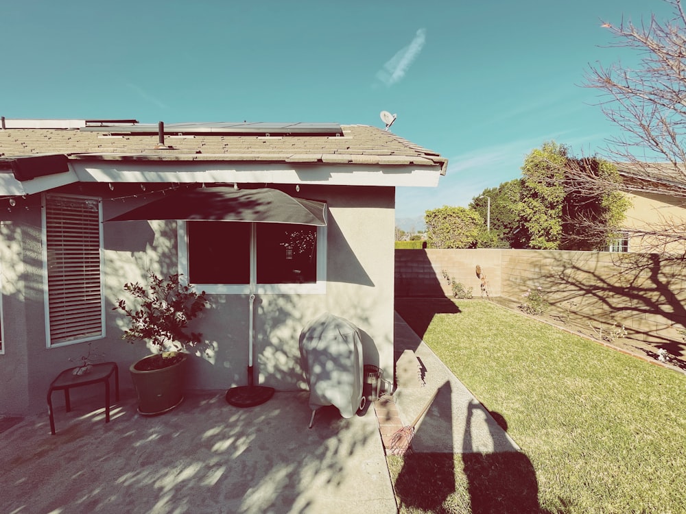 white and brown concrete house near green trees under blue sky during daytime