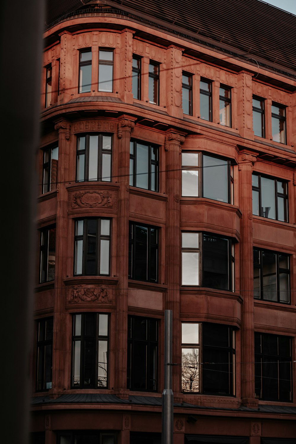 brown concrete building with glass windows