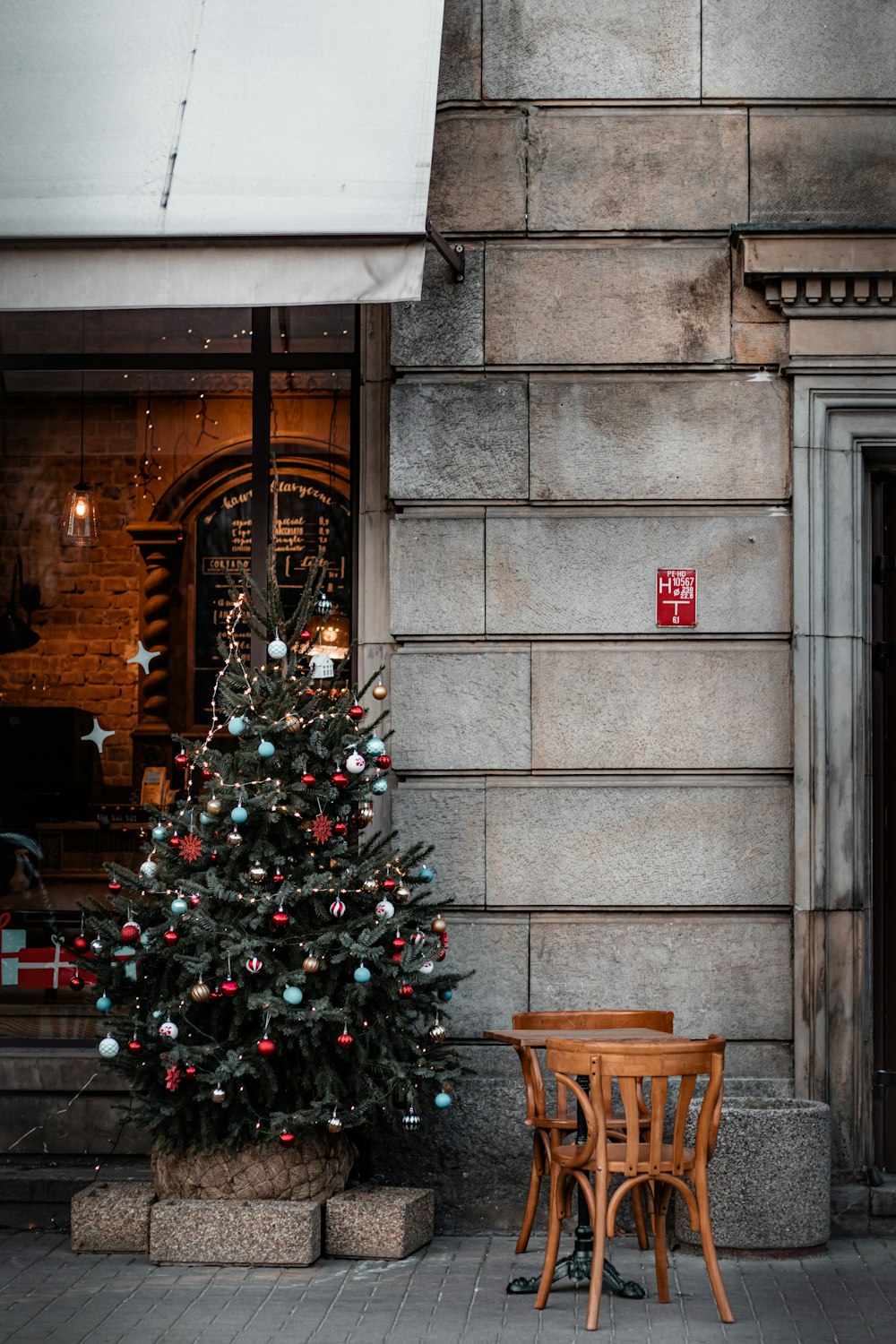 green christmas tree with red baubles and string lights