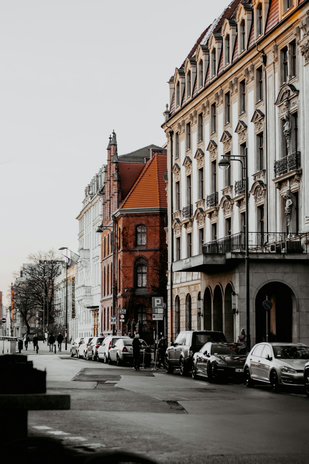 cars parked in front of brown concrete building during daytime