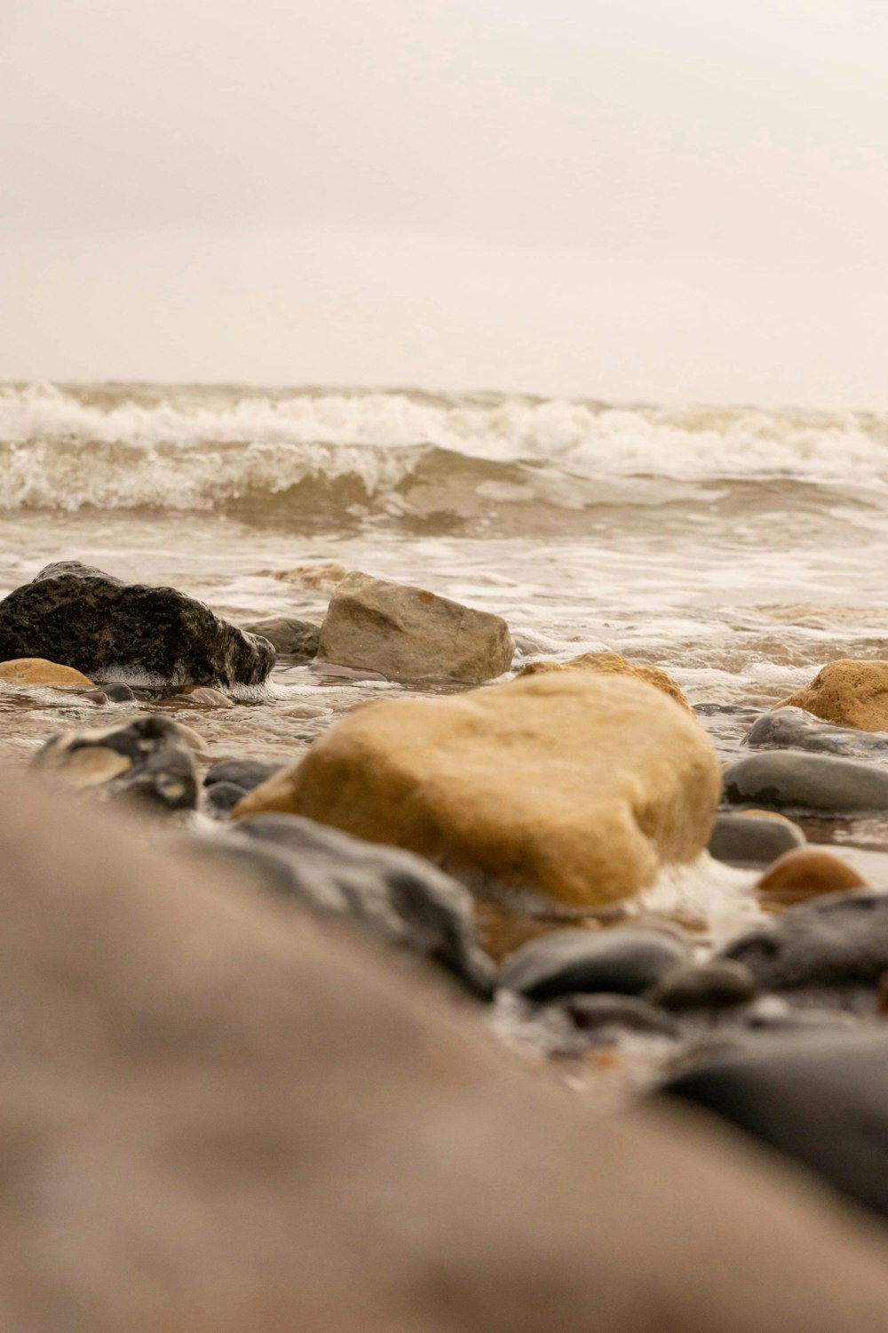 brown and gray rocks on sea shore during daytime