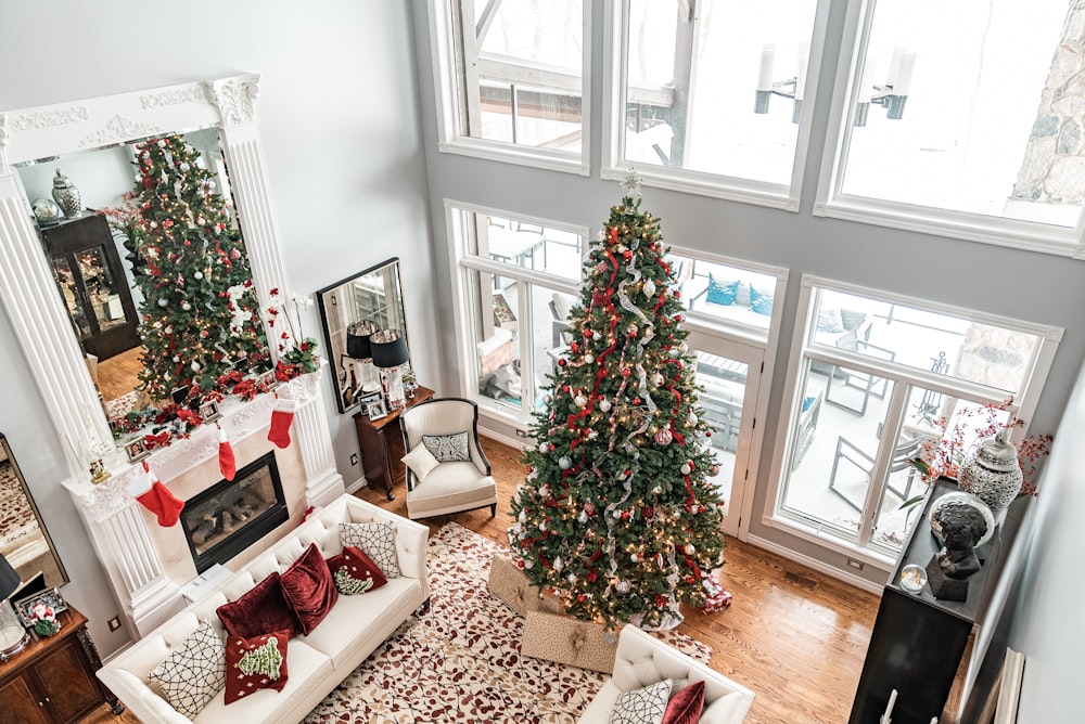 green christmas tree with baubles near window