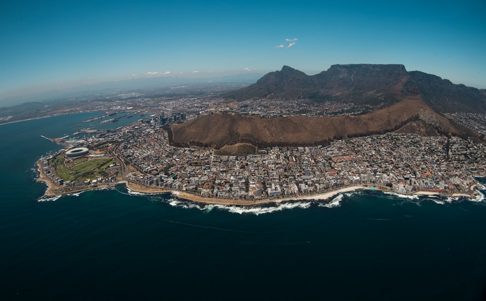 aerial view of city near body of water during daytime