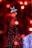 A smiling customer stands next to a beautifully decorated Christmas tree.