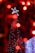 A smiling customer stands next to a beautifully decorated Christmas tree.