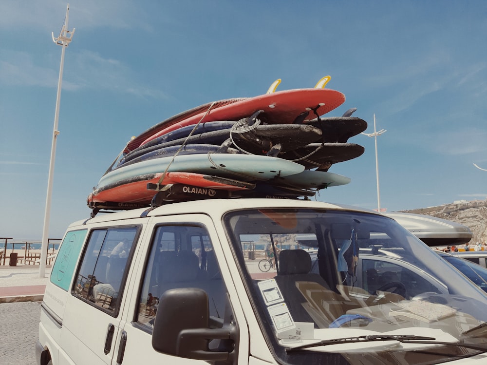 orange and white surfboard on white van