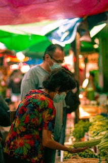 A colorful market scene full of people and fresh produce.
