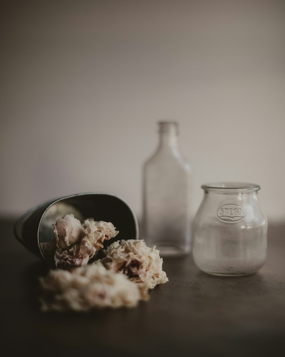 clear glass bottle with white powder