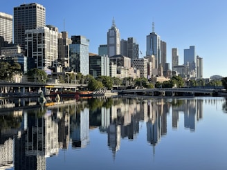 body of water near city buildings during daytime