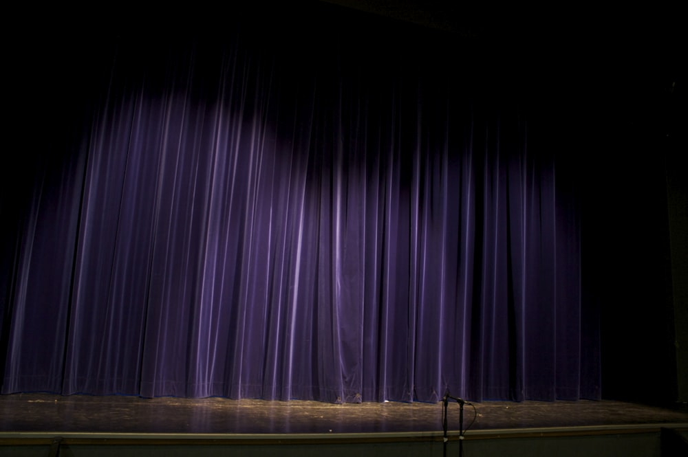 purple curtain on window during daytime