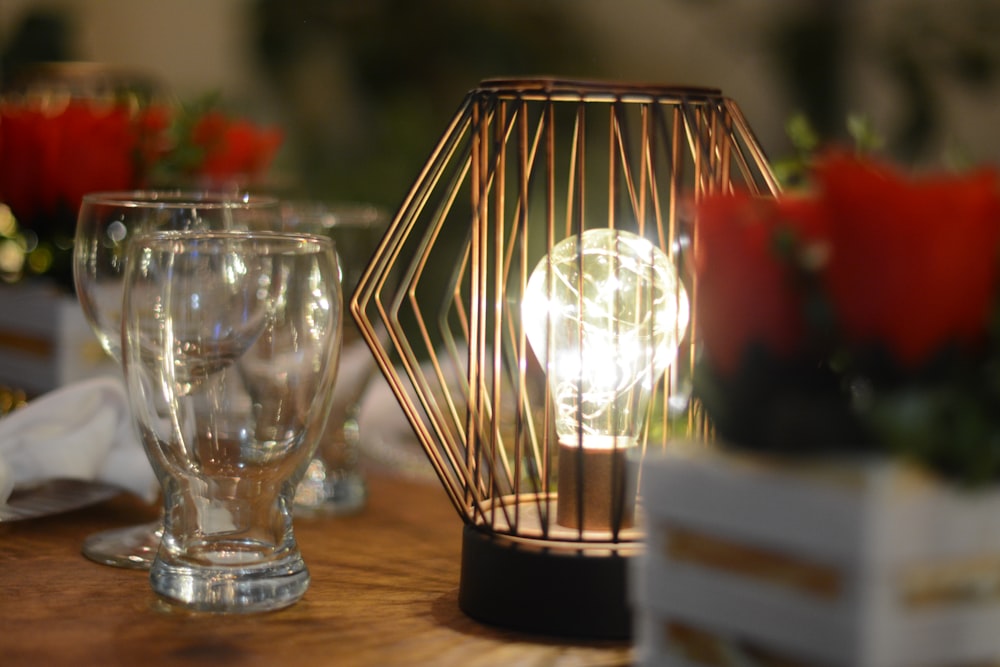 clear glass candle holder on brown wooden table