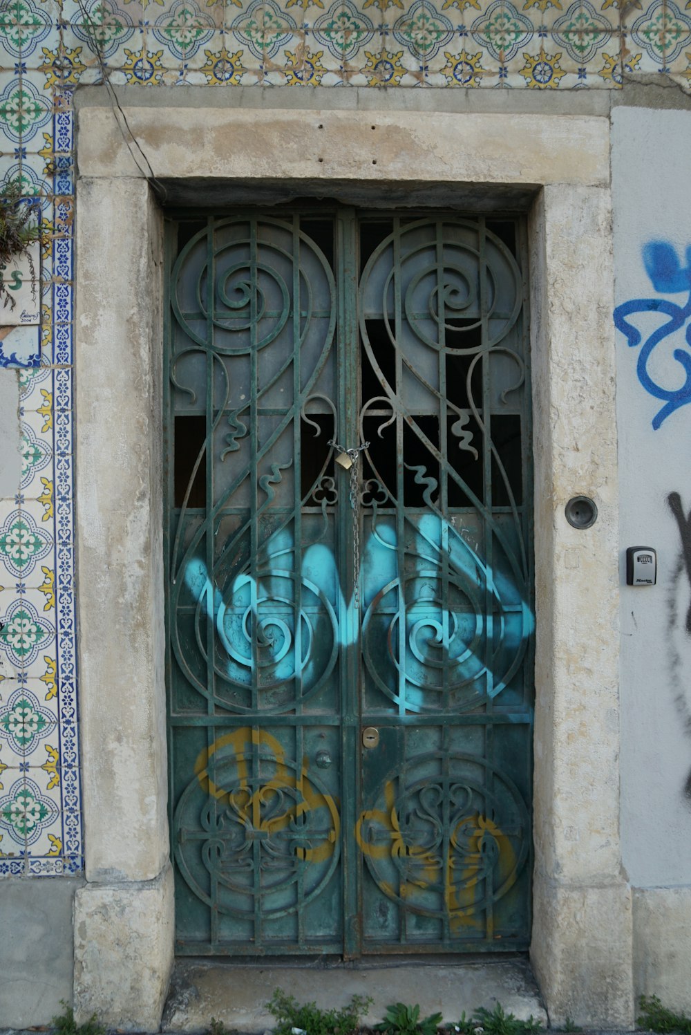 blue wooden door with white steel door