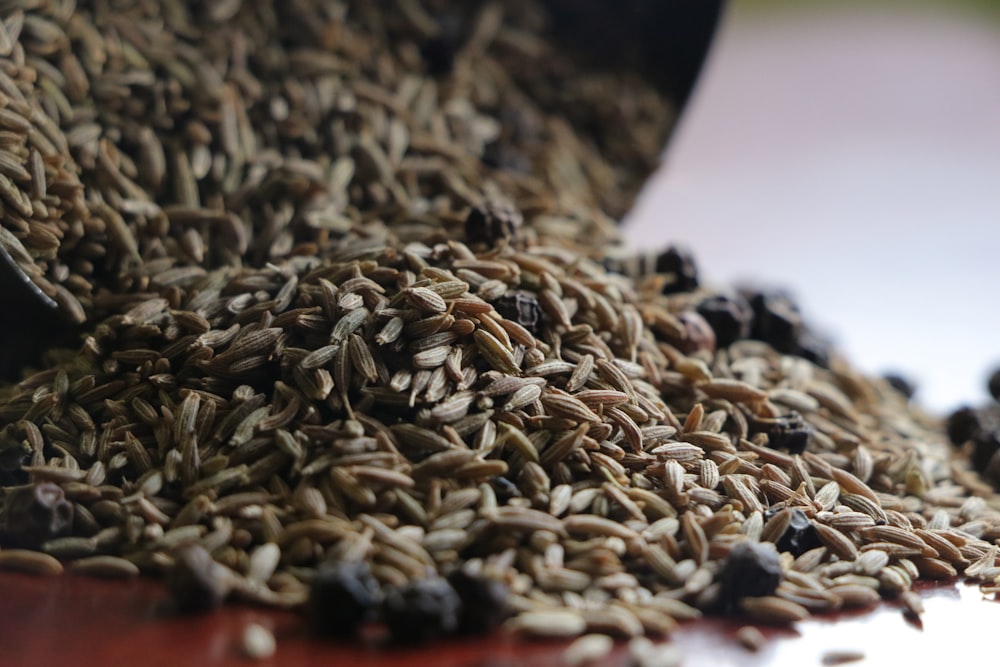 brown and black seeds on brown wooden table