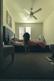 woman in black t-shirt and black shorts standing on black area rug