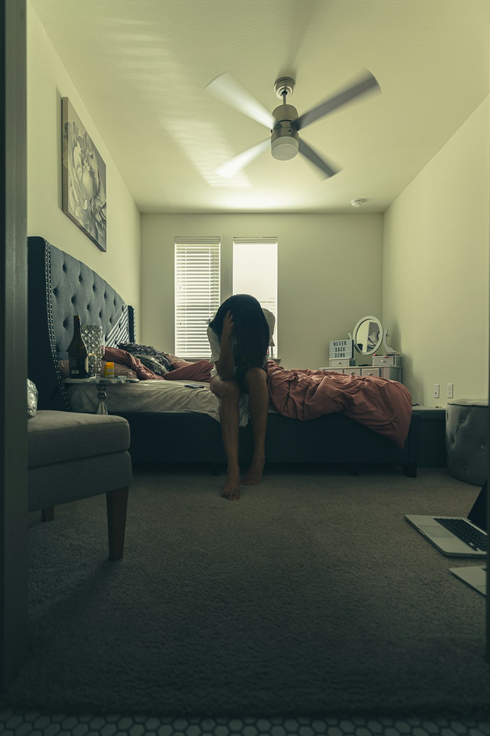 woman in black t-shirt and black shorts standing on black area rug